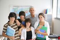 A teacher standing with four other students